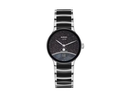 Damenuhren Uhr mit Datum aus Edelstahl und Keramik. Das Gehäuse ist rund und silber. Das Edelstahlarmband ist silber. Das Zifferblatt ist ohne Zeichen und schwarz.