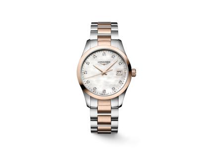 Longines Conquest Classic Quarz Edelstahl 34mm weißes Perlmutt-Zifferblatt mit Diamanten Metallband – Damenuhren Uhr mit Datum aus Edelstahl. Das Gehäuse ist rund und silber-roségold. Das Edelstahlarmband ist silber-roségold. Das Zifferblatt ist ein Index in weiß.