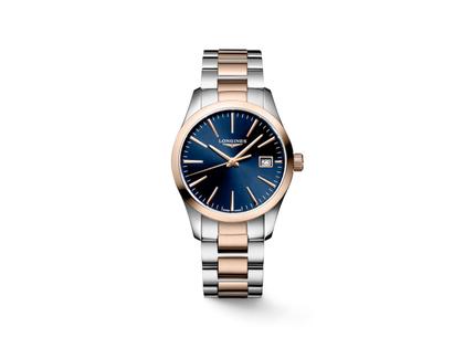 Longines Conquest Classic Quarz Edelstahl 34mm blaues Zifferblatt Metallband – Damenuhren Uhr mit Datum aus Edelstahl. Das Gehäuse ist rund und silber-roségold. Das Edelstahlarmband ist silber-roségold. Das Zifferblatt ist ein Index in blau.