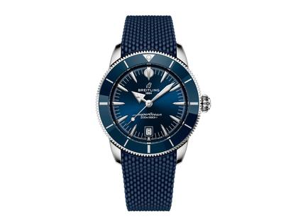 Herrenuhren Uhr mit Datum aus Edelstahl, Kautschuk und Keramik. Das Gehäuse ist rund und silber. Das Kautschuk / Kunststoff / Silikon Armband ist blau. Das Zifferblatt ist ein Index in blau.