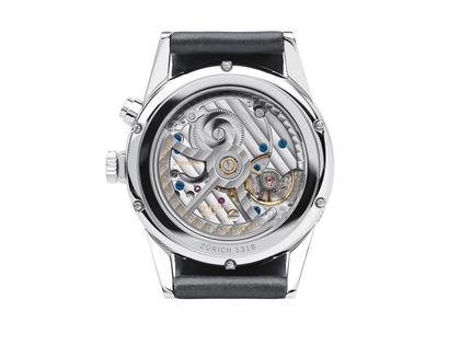 Nomos Glashütte Zürich Weltzeit Automatik Edelstahl 40mm weißes Zifferblatt schwarzes Lederband – Herrenuhren Uhr ohne Datum aus Edelstahl und Leder. Das Gehäuse ist rund und silber. Das Lederarmband ist schwarz. Das Zifferblatt ist ein Index in weiß. – Ansicht 2