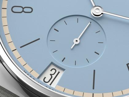 Nomos Glashütte Tangente 38 Datum "175 Years Watchmaking - Frostblau" Handaufzug Edelstahl eisblaues Zifferblatt graues Textilband Glasboden – Herrenuhren Uhr mit Datum aus Edelstahl. Das Gehäuse ist rund und silber. Das Textilarmband ist grau. Das Zifferblatt ist arabisch Index und blau. – Ansicht 5