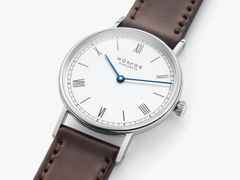 Nomos Glashütte Ludwig 33 Emailleweiß Handaufzug Edelstahl weißes Zifferblatt braunes Lederband Glasboden – Damenuhren Uhr ohne Datum aus Edelstahl. Das Gehäuse ist rund und silber. Das Lederarmband ist braun. Das Zifferblatt ist römisch Index und weiß. – Ansicht 2