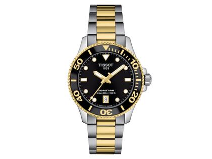 Tissot Seastar 1000 Quarz Edelstahl bicolor 36 mm schwarzes Zifferblatt Metallband bicolor – Damenuhren Uhr mit Datum aus Edelstahl, Keramik und PVD beschichtet. Das Gehäuse ist rund und silber-gelbgold. Das Edelstahlarmband ist silber-gelbgold. Das Zifferblatt ist ein Index in schwarz.