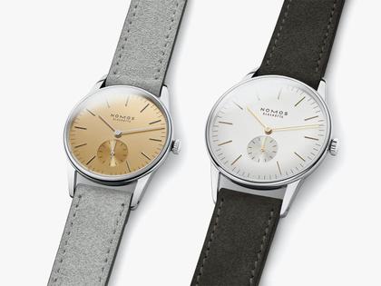 Nomos Glashütte Orion 33 Gold Handaufzug Edelstahl 33mm goldfarbenes Zifferblatt graues Lederband Glasboden – Damenuhren Uhr ohne Datum aus Edelstahl und Leder. Das Gehäuse ist rund und silber. Das Lederarmband ist beige. Das Zifferblatt ist ein Index in beige. – Ansicht 5