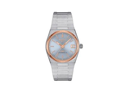 Tissot PRX Automatik Edelstahl 35mm blaues Zifferblatt Metallband – Damenuhren Uhr mit Datum aus 750 Rotgold und Edelstahl. Das Gehäuse ist rund und silber. Das Edelstahlarmband ist silber. Das Zifferblatt ist ein Index in blau.