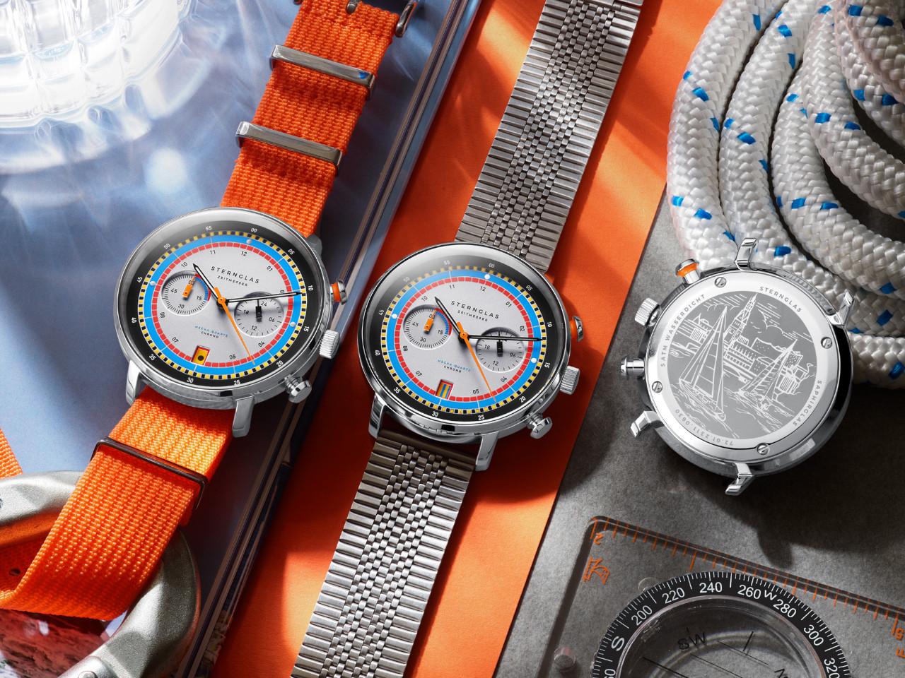 Sternglas Hamburg Edition Hafen Quarz Edelstahl 42mm mehrfarbiges Zifferblatt orangefarbenes Textilband – Herrenuhren Uhr mit Datum aus Edelstahl und Leder. Das Gehäuse ist rund und silber. Das Textilarmband ist orange. Das Zifferblatt ist arabisch Index und mehrfarbig. – Ansicht 4