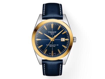 Herrenuhren Uhr mit Datum aus 750 Gelbgold, Edelstahl und Metall. Das Gehäuse ist rund und silber. Das Edelstahlarmband ist blau. Das Zifferblatt ist ein Index in silber.