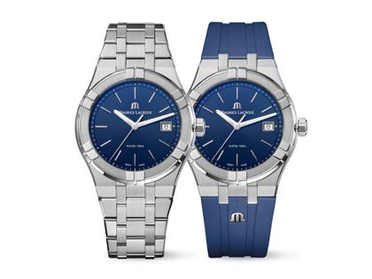 Maurice Lacroix Aikon Date Quarz Edelstahl 40mm blaues Zifferblatt Metallband und blaues Kautschukband – Herrenuhren Uhr mit Datum aus Edelstahl, Kautschuk, PVD beschichtet und vergoldet. Das Gehäuse ist rund und silber. Das Edelstahlarmband ist silber. Das Zifferblatt ist ein Index in blau.