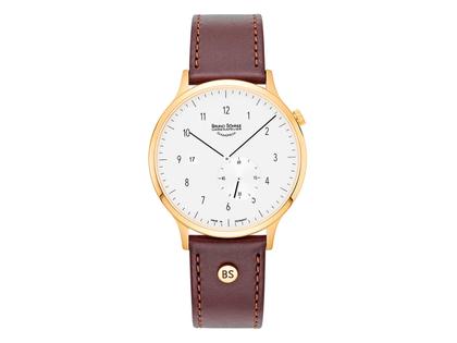 Bruno Söhnle Glashütte Brunello I Quarz Edelstahl gelbvergoldet cremefarbenes Zifferblatt braunes Lederband – Herrenuhren Uhr mit Datum aus Edelstahl und IP beschichtet. Das Gehäuse ist rund und gelbgold. Das Lederarmband ist braun. Das Zifferblatt ist arabisch Index und beige.