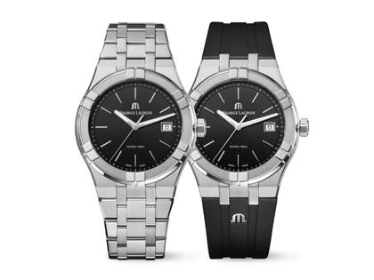 Maurice Lacroix Aikon Date Quarz Edelstahl 40mm schwarzes Zifferblatt Metallband und schwarzes Kautschukband – Herrenuhren Uhr mit Datum aus Edelstahl, Kautschuk, PVD beschichtet und vergoldet. Das Gehäuse ist rund und silber. Das Edelstahlarmband ist silber. Das Zifferblatt ist ein Index in schwarz.