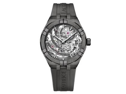 Maurice Lacroix Aikon Manufacture Skeleton Automatik Edelstahl Grau-PVD 45mm skelettiertes Zifferblatt graues Kautschukband limitiert – Herrenuhren Uhr ohne Datum aus Edelstahl, Kautschuk und PVD beschichtet. Das Gehäuse ist rund und grau. Das Kautschuk / Kunststoff / Silikon Armband ist grau. Das Zifferblatt ist skelettiert und grau.