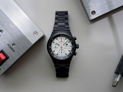 Porsche Design Chronograph 1 - F.A.T. 2025 Edition – Herrenuhren Chronograph aus Titan und Titancarbid beschichtet. Das Gehäuse ist rund und schwarz. Das Titanarmband ist schwarz. Das Zifferblatt ist ein Index in weiß. – Ansicht 12