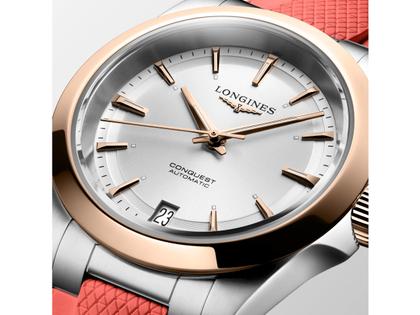 Longines Conquest Automatik Edelstahl 34mm silberfarbenes Zifferblatt orangefarbenes Kautschukband – Damenuhren Uhr mit Datum aus 750 Rotgold, Edelstahl und Kautschuk. Das Gehäuse ist rund und silber. Das Kautschuk / Kunststoff / Silikon Armband ist orange. Das Zifferblatt ist ein Index in silber. – Ansicht 5