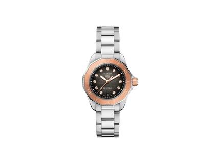 TAG Heuer Aquaracer Professional 200 Date Automatik Edelstahl 30mm schwarzes Perlmutt-Zifferblatt mit Brillanten Metallband – Damenuhren Uhr mit Datum aus 750 Gelbgold und Edelstahl. Das Gehäuse ist rund und silber. Das Edelstahlarmband ist silber. Das Zifferblatt ist ein Index in schwarz.