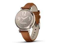 Garmin Lily 2 Smartwatch Aluminium eloxiert 35mm cremegoldfarbenes Display tanbraunes Lederband – Damenuhren Uhr Multifunktion aus eloxiertes Aluminium, Kunststoff und Polyamid. Das Gehäuse ist rund. Das Lederarmband ist braun. Der Zifferblatt ist digital.