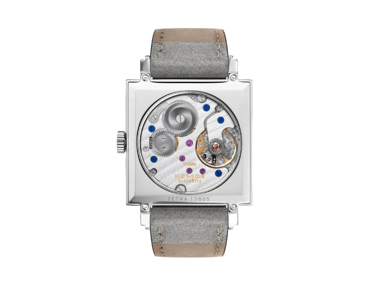 Nomos Glashütte Tetra Berliner Mischung Goldelse Handaufzug Edelstahl 29mm lachsfarbenes Zifferblatt graues Lederband – Damenuhren Uhr ohne Datum aus Edelstahl. Das Gehäuse ist quadratisch und silber. Das Lederarmband ist grau. Das Zifferblatt ist arabisch Index und roségold. – Ansicht 2