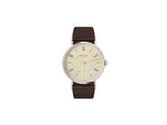 Nomos Glashütte Tangente 33 Karat Handaufzug Edelstahl 33mm vergoldetes Zifferblatt braunes Lederband Glasboden – Damenuhren Uhr ohne Datum aus Edelstahl und Leder. Das Gehäuse ist rund und silber. Das Lederarmband ist braun. Das Zifferblatt ist arabisch Index und gelbgold.