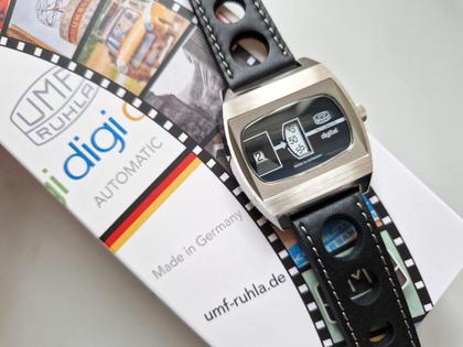 UMF Ruhla Scheibenuhr Automatik mit springender Stunde Edelstahl 41mm schwarzes Zifferblatt schwarzes Lederband limitiert – Herrenuhren Uhr ohne Datum aus Edelstahl, Keramik und Leder. Das Gehäuse ist tonneauform und silber. Das Lederarmband ist schwarz. Das Zifferblatt ist digital und schwarz. – Ansicht 3