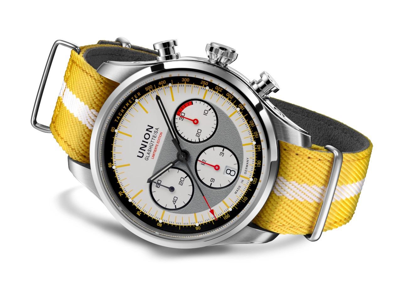 Union Glashütte Belisar Chronograph Silvretta Classic 2026 Limitierte Edition Automatik Edelstahl 44mm beiges Zifferblatt gelbes Textilband schwarzes Lederband und Metallband – Herrenuhren Chronograph aus Edelstahl und Leder. Das Gehäuse ist rund und silber. Das Textilarmband ist gelb. Das Zifferblatt ist ein Index in beige. – Ansicht 3